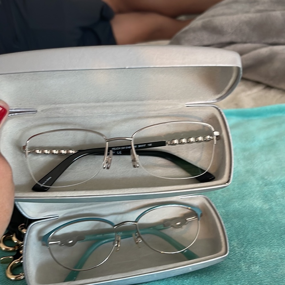 2 Swarovski Glasses with original case and cloth.